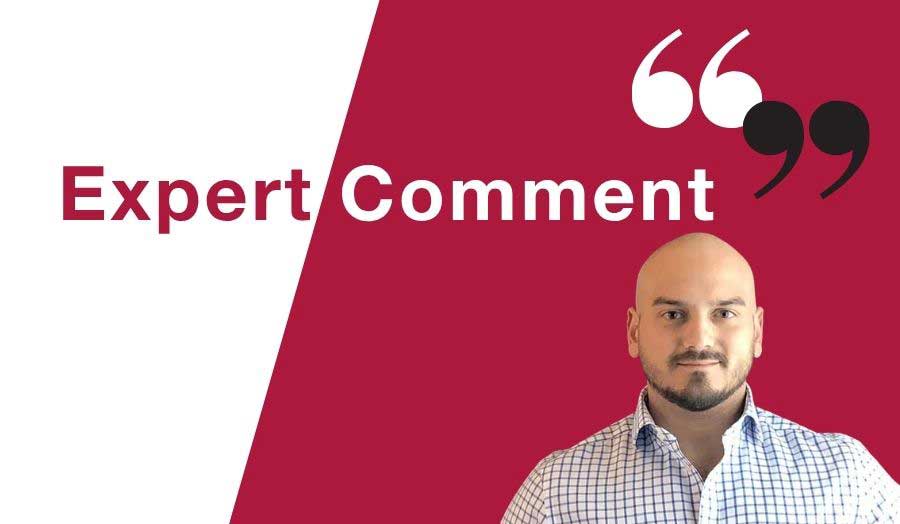 Man in shirt and beard sits in front of Expert Comment banner