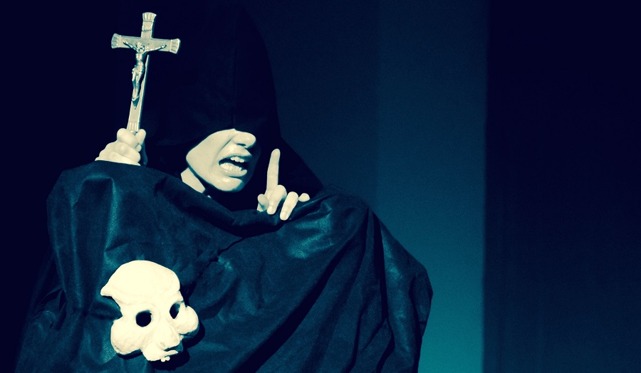 A gothic image of a woman raising hand with a crucifix