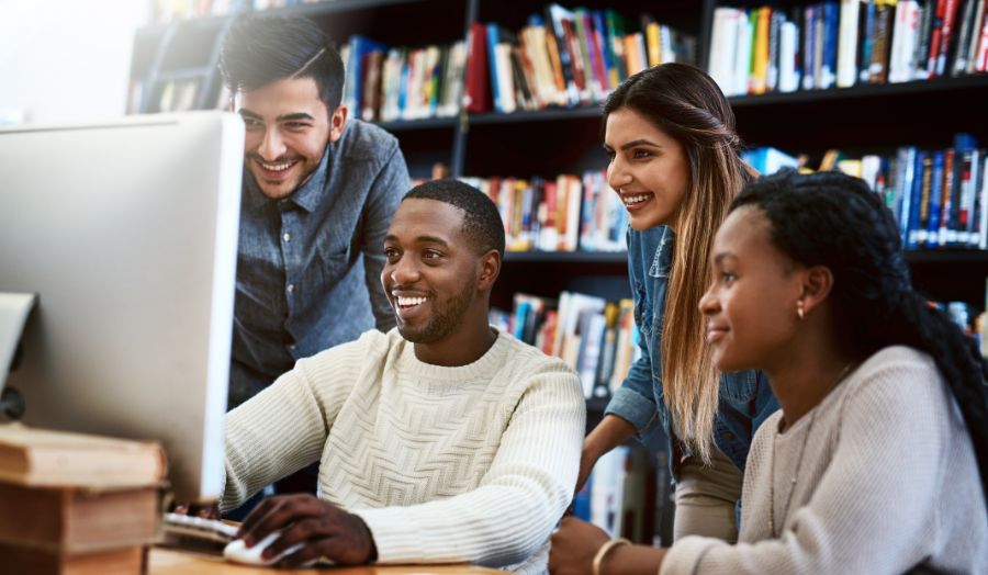 A group of students are looking at the computer screen.