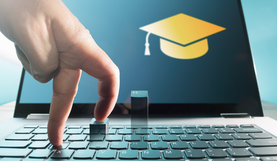 Image of a computer with a graduation hat on the screen