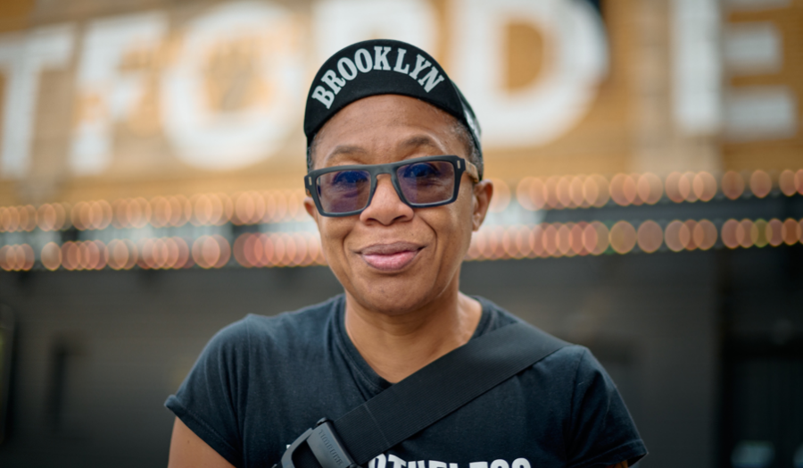 A person wearing a black hat on an out of focus background