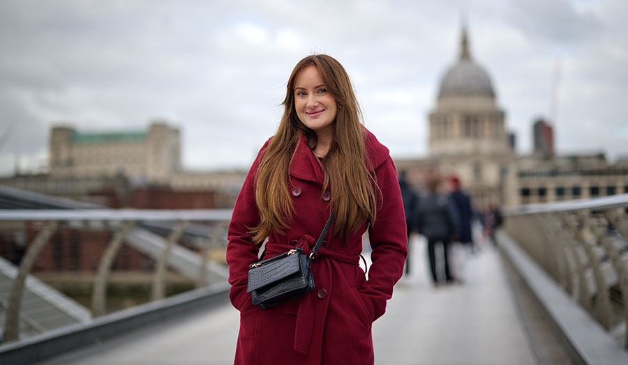 Ena standing on the wobbly bridge with St Pauls in the background