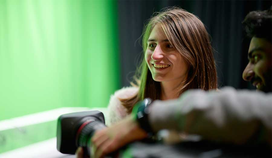 Stefani with another student playing with video camera equipment