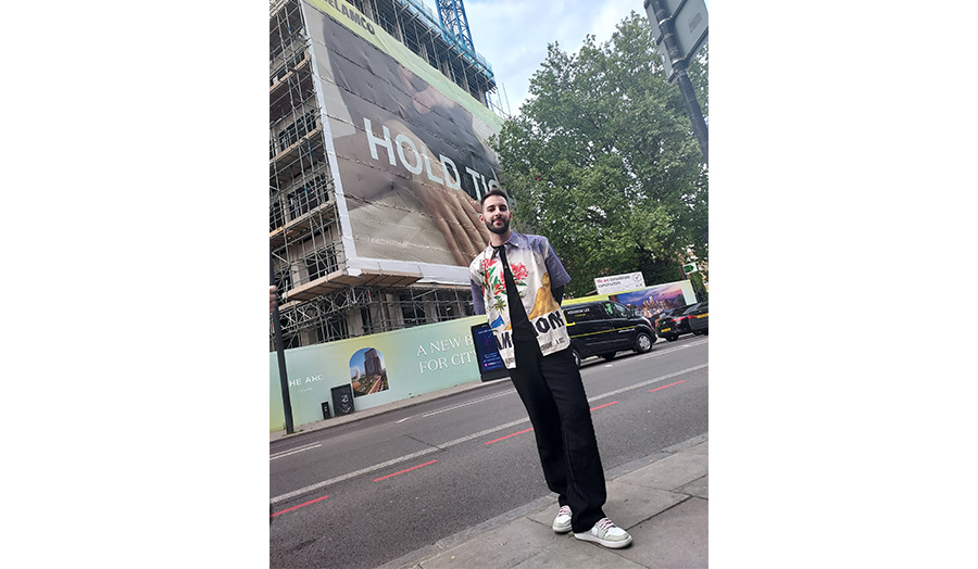 David pictured on City Road with his artwork behind him