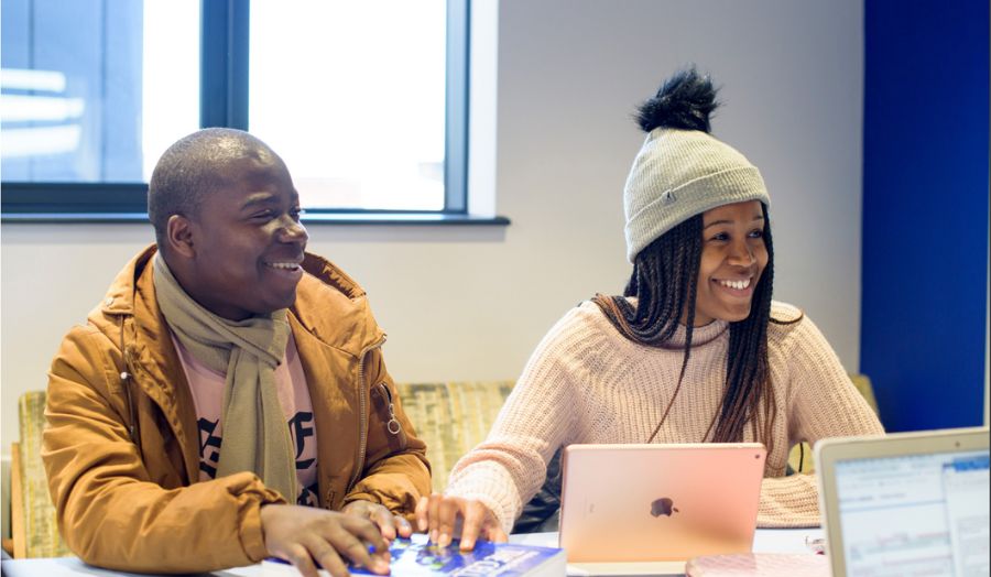 Two young people working at a table