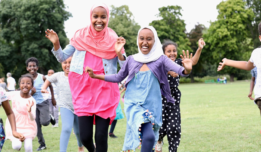youths running across a park
