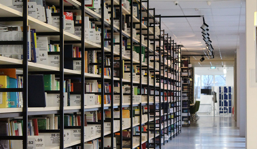 A shelf with stacked books in the library