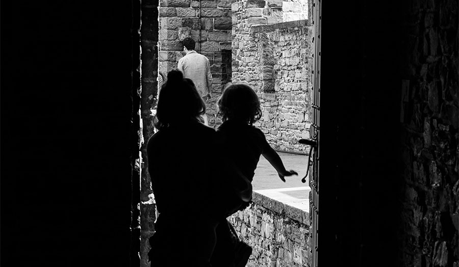 A silhouette of a woman holding a small child