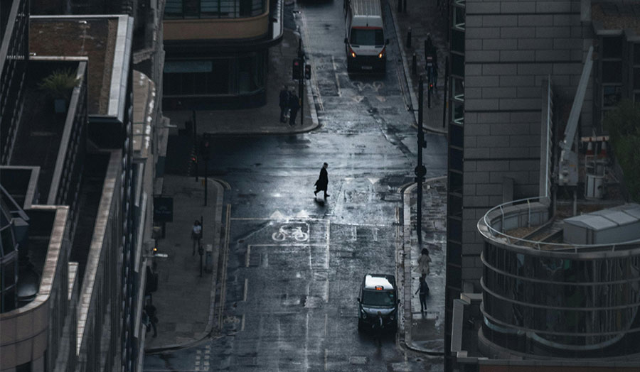 An aerial shot of a person walking alone on London streets