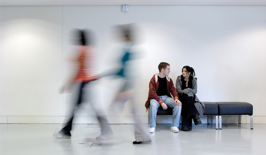 Students sitting in the grad centre wih blurred walkers