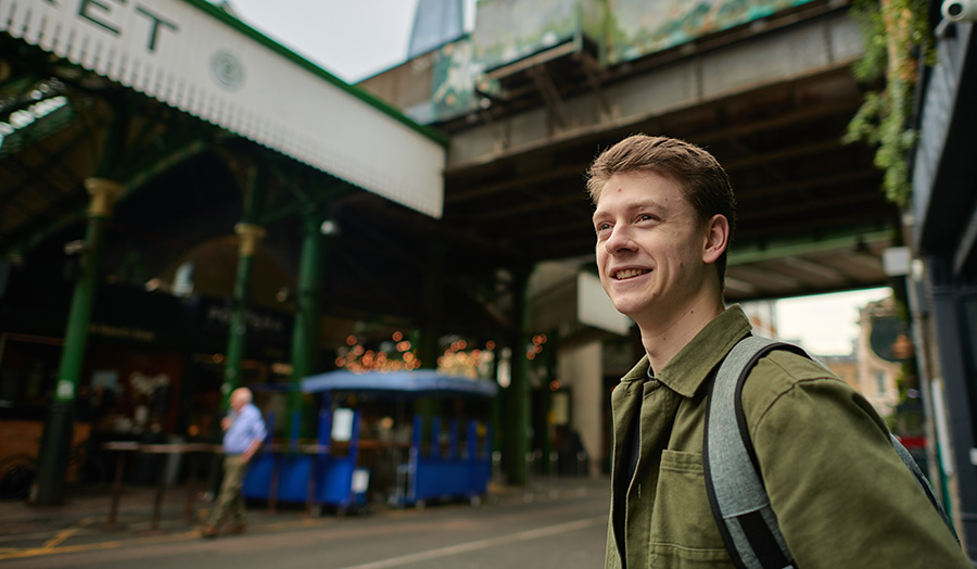 A person standing outside Borough Market in London